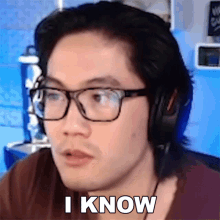 a man wearing glasses and headphones is saying " i know "