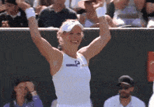 a woman in a white top with the letter p on it