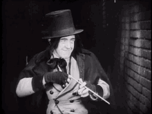 a man in a top hat and gloves is holding a stick