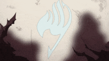 a fairy tail logo is displayed on a white surface
