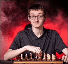 a man with glasses and a mustache playing a game of chess