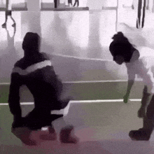 a man and a woman are playing a game of volleyball