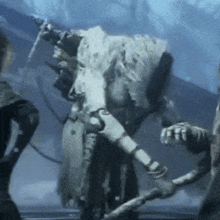 a skeleton is holding a sword and a stick in a dark room .