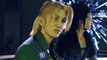 a woman with blonde hair is sitting next to a man with black hair