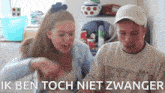 a man and a woman are sitting next to each other with the words ik ben toch niet zwanger in the corner