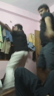 a group of men are dancing in a room