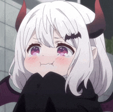 a girl with horns and a bat on her head is making a funny face