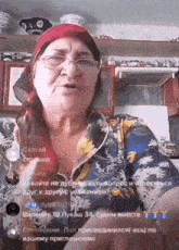 an older woman wearing glasses and a head scarf is talking to someone