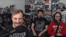 a man wearing a stephen t-shirt is sitting in front of a microphone
