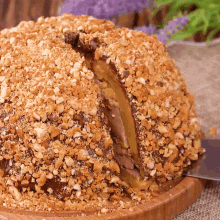 a cake with nuts on top of it and a slice taken out