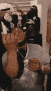 a man is giving the middle finger at a party .