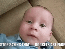 a baby is laying on a couch with the caption stop saying that rockets are fake .