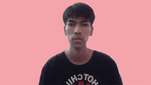 a young man wearing a black shirt that says hcton