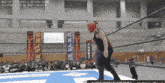 a wrestler in a ring with a sign that says best of the suffer on it