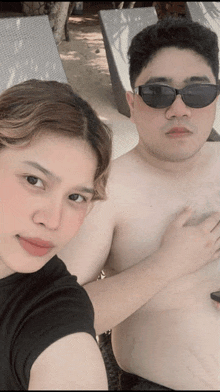 a man and a woman wearing sunglasses pose for a photo