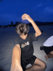 a person wearing a black shirt that says zufs on the front