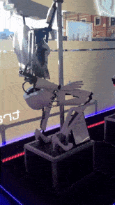 a display of a robot with a sign that says ' snj ' in the background