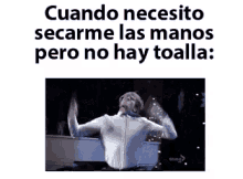 a man in a white shirt is dancing with his arms outstretched in front of a piano .