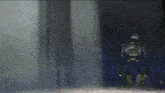 a robot is standing in front of a blue curtain in a dark room