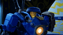a lego character is sitting in a blue robot with a light on it