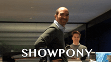 a man stands in front of a sign that says " showpony "