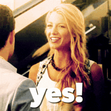 a woman is smiling next to a man and the word yes is visible