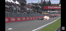 a race track with a banner that says fly emirates on it