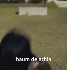 a blurred image of a person with the words " haum de athia " written on the bottom