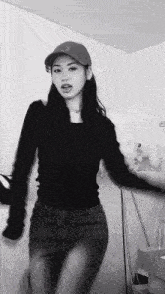 a black and white photo of a woman in a hat