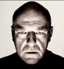 a close up of a man 's face with a serious look on his face