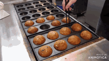 a bunch of cupcakes are being cooked in a pan with the words made in animotica on the bottom right