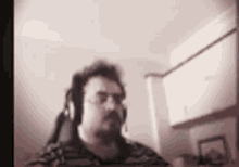 a blurry picture of a man wearing headphones .