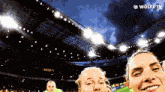a soccer player takes a selfie with a wolfe tv logo behind her
