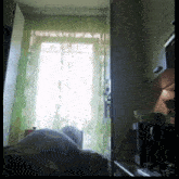 a kitchen with a green curtain and a microwave