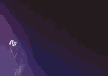 a man in a robe is making a funny face in a black and purple photo .