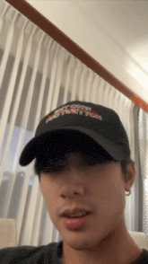 a man wearing a black hat that says " i love you "