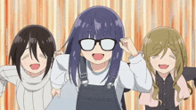 three anime girls are posing for a picture and one of them has glasses on