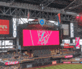 a large chase field sign hangs above a stadium
