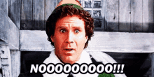a man in a christmas elf costume is making a surprised face and saying no 000000 !!!