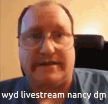 a close up of a man 's face with the words " wyd livestream nancy dm " below him