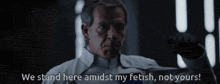 a man is holding a knife and saying we stand here amidst my fetish , not yours .