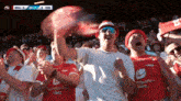 a group of people in a stadium with one wearing a shirt that says " sparebanken vest "