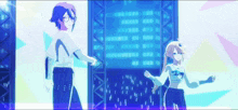 two anime characters are dancing in front of a screen