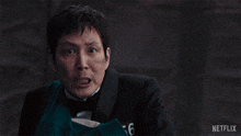 a man in a tuxedo with the number 456 on it