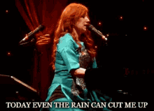 a woman singing into a microphone with the words " today even the rain can cut me up " below her