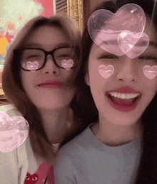 two women with hearts on their faces and glasses