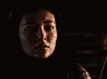 a close up of a woman 's face with a tear coming out of her eye