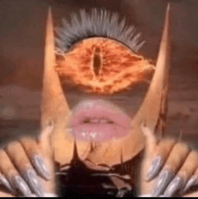 a close up of a woman 's face with horns and a large eye .