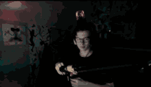 a man in a dark room holding a flashlight