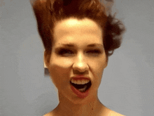 a woman with her mouth open making a funny face